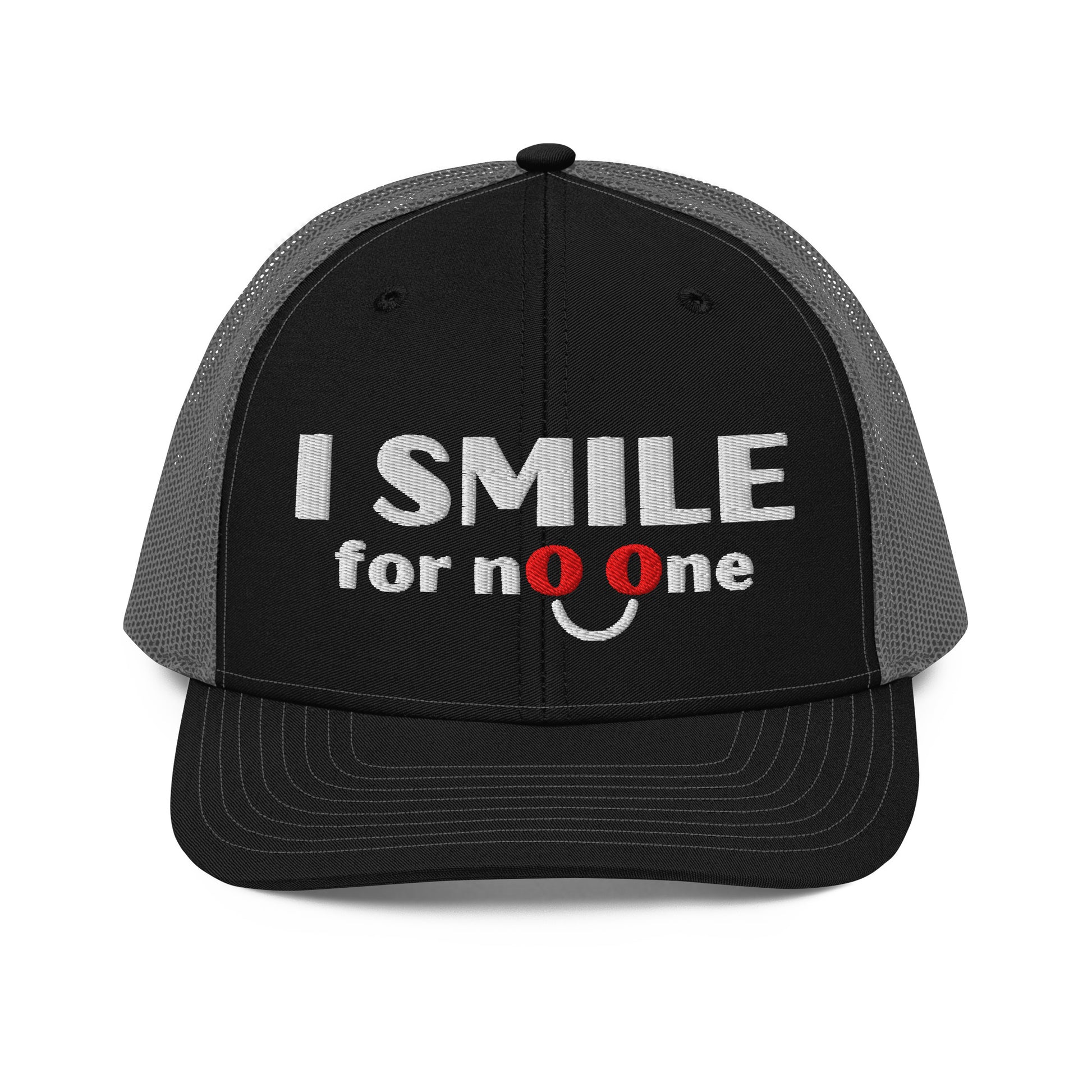 Black and grey trucker hat with embroidered text 'I Smile for No One' in bold white lettering. Structured cap with mesh back and adjustable snapback.
