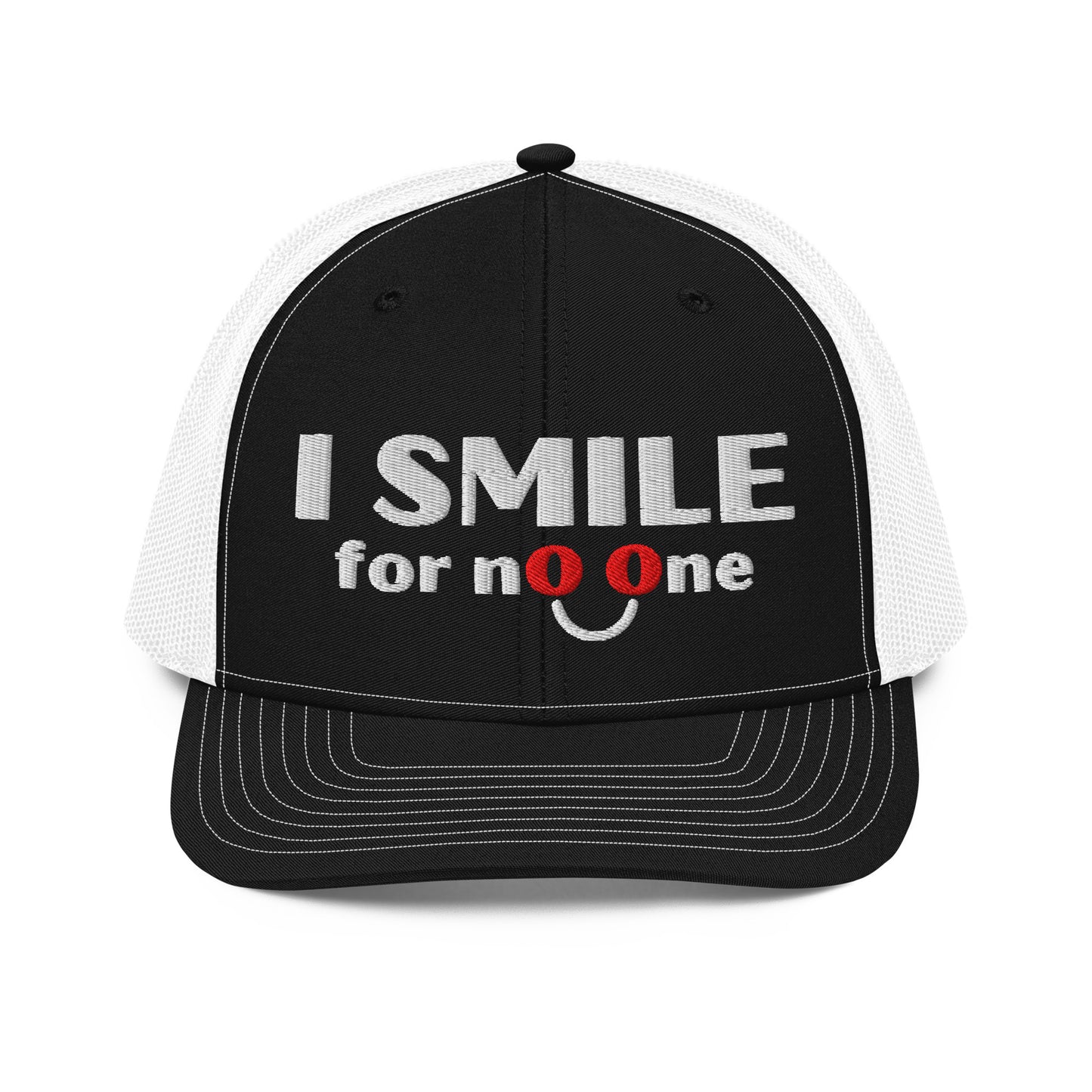 Black and white trucker hat with embroidered text 'I Smile for No One' in bold white lettering. Structured cap with white mesh back and adjustable snapback.