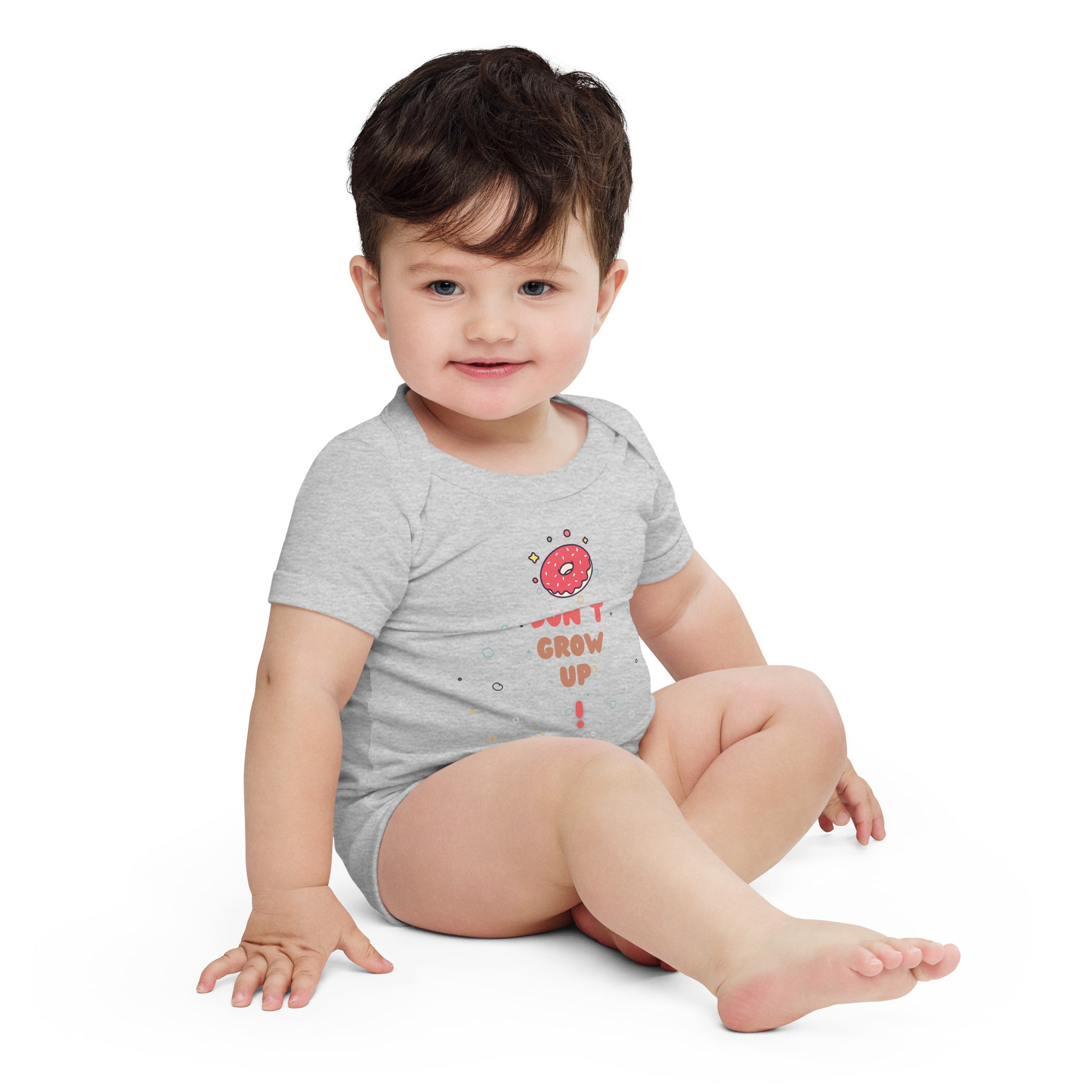 Baby in a grey onesie with "Don't Grow Up!" with donut caption.