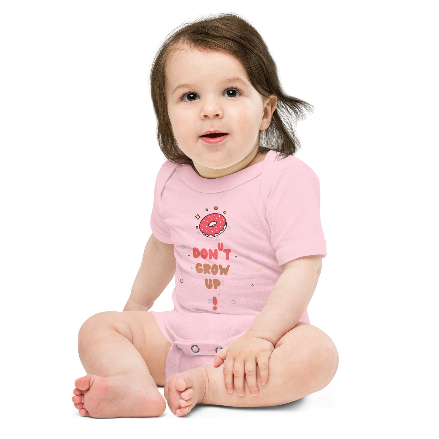 Baby in a pink onesie with "Don't Grow Up!" with donut caption.