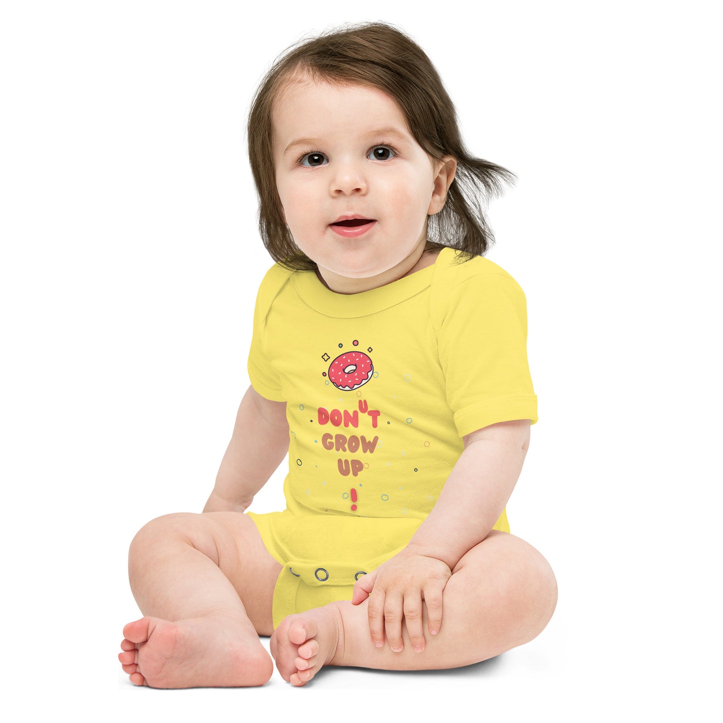 Baby in a yellow onesie with "Don't Grow Up!" with donut caption.