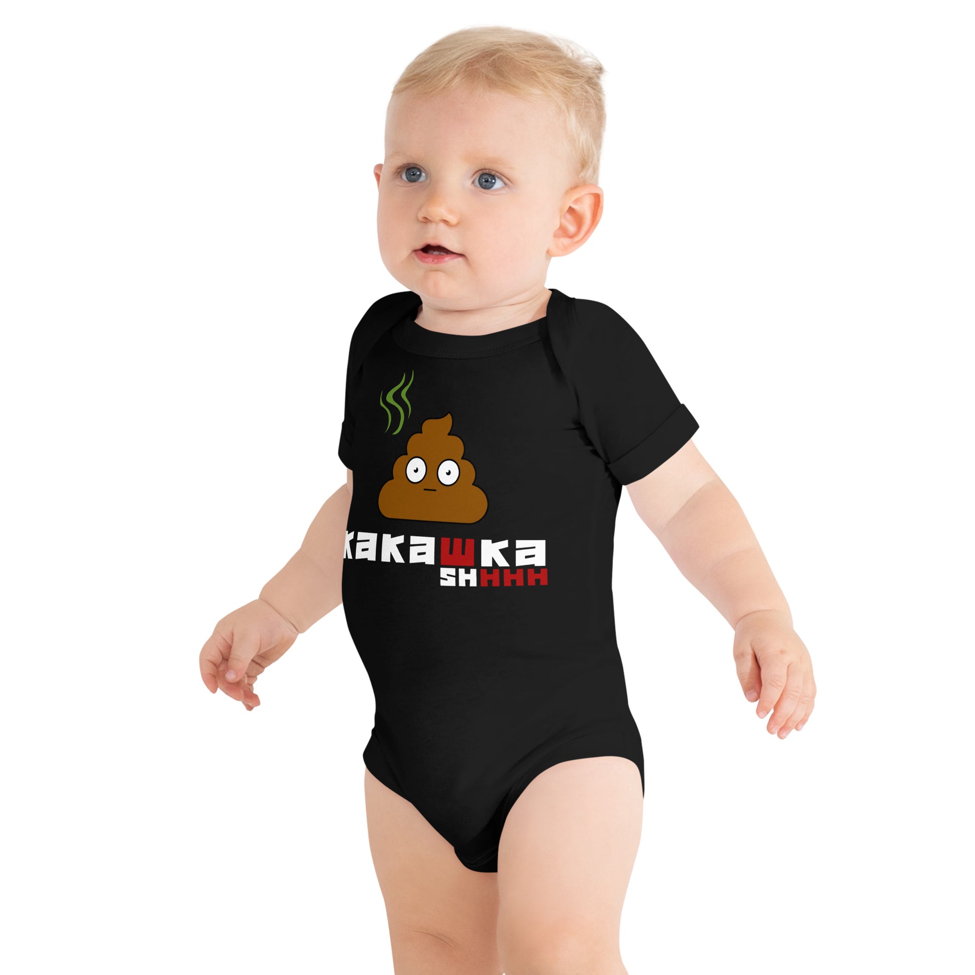 baby in black one piece onesie with picture of poop and kakashka written on it