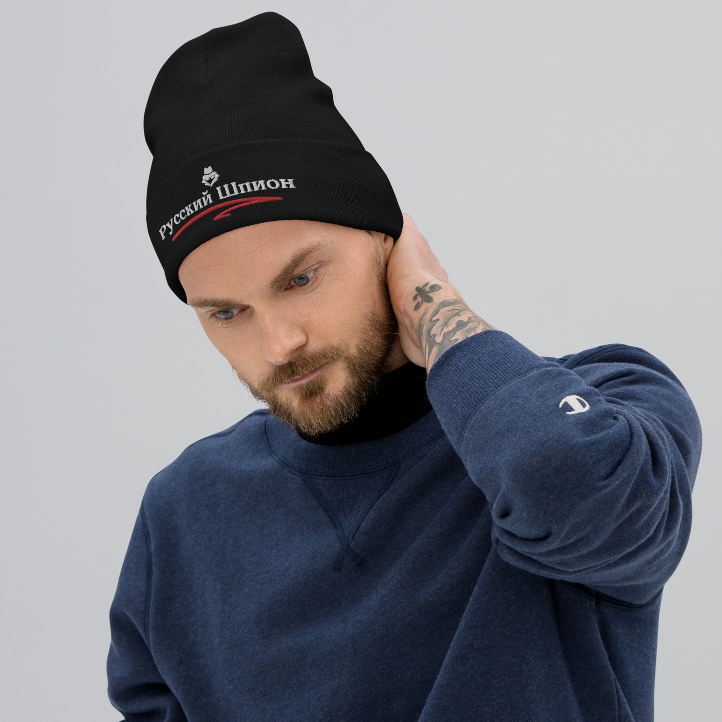 russian spy embroidered in russian on a black beanie on a man