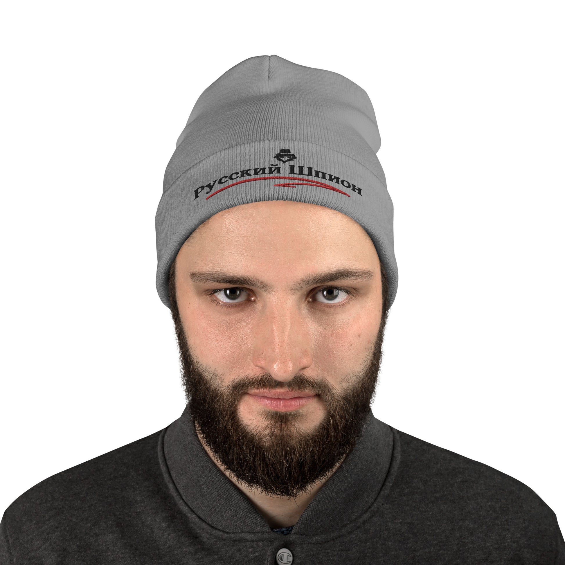 man wearing russian spy embroidered in russian on a gray beanie