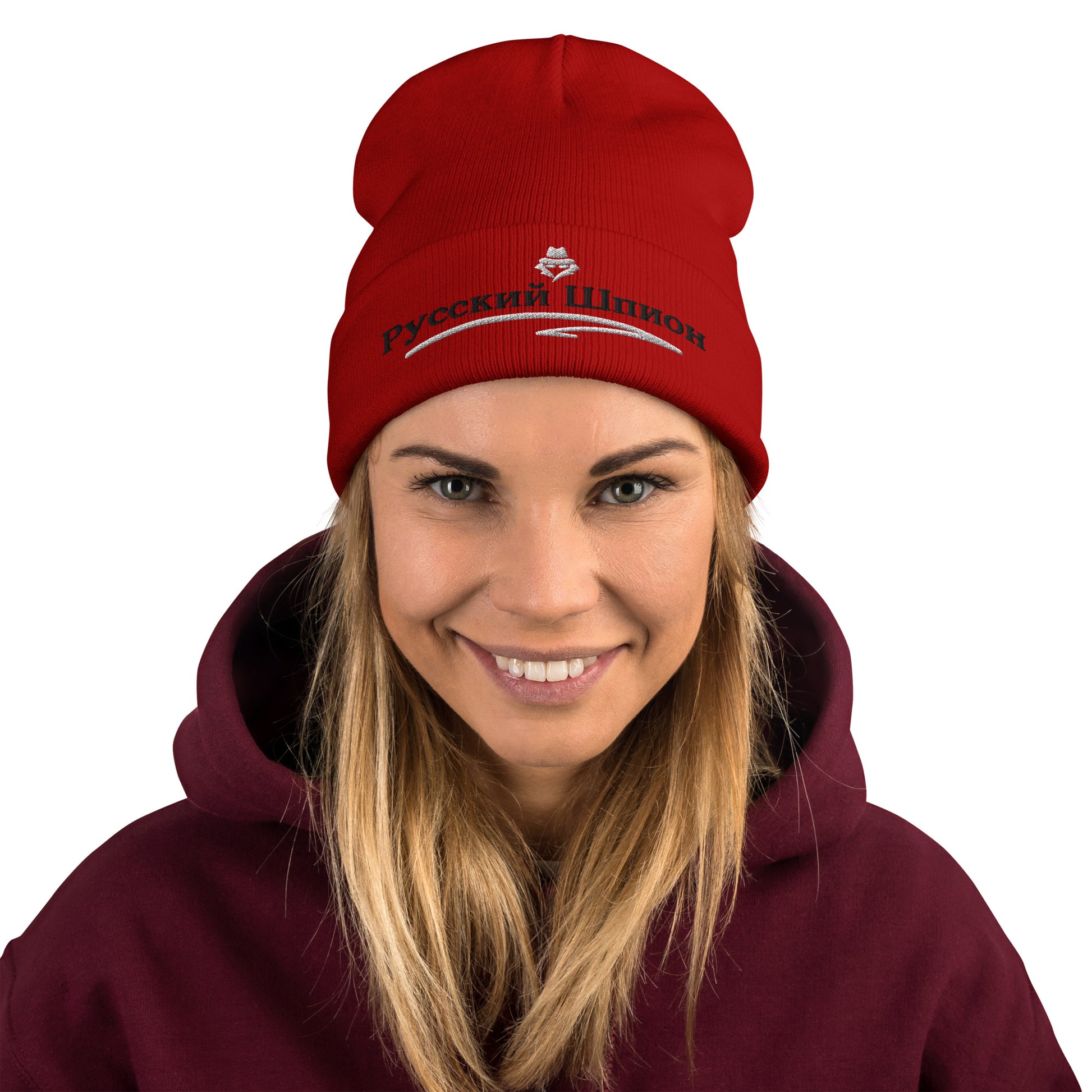 woman wearing russian spy embroidered in russian on a red beanie