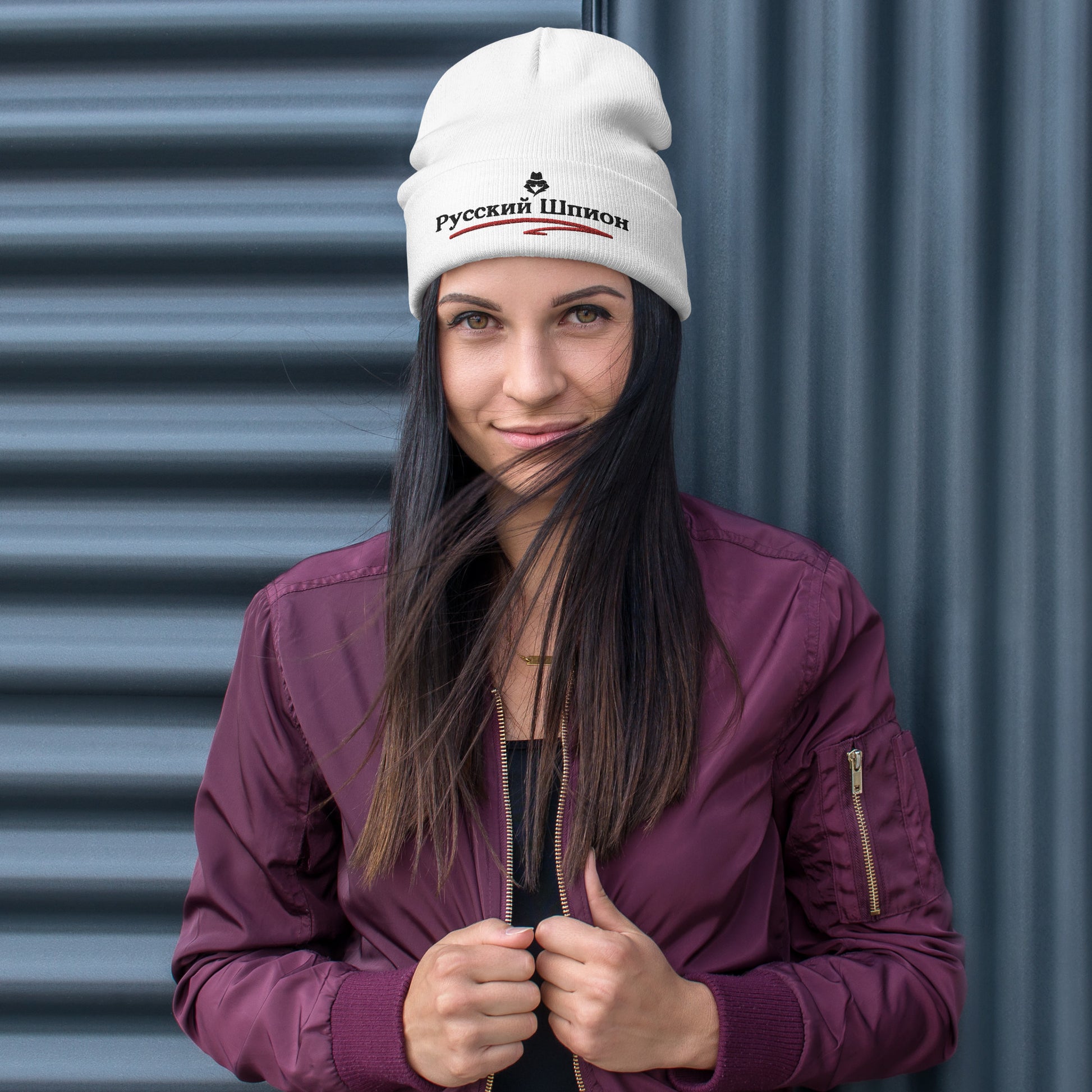 woman wearing russian spy embroidered in russian on a white beanie