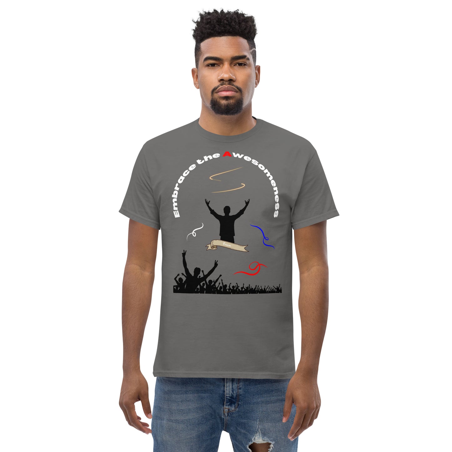 man in charcoal grey tshirt with words embrace the awesomeness inscribed in a half circle around a man with arms raised up you see whate blue and red colors featured and a crowd of people cheering in the background from the bottom