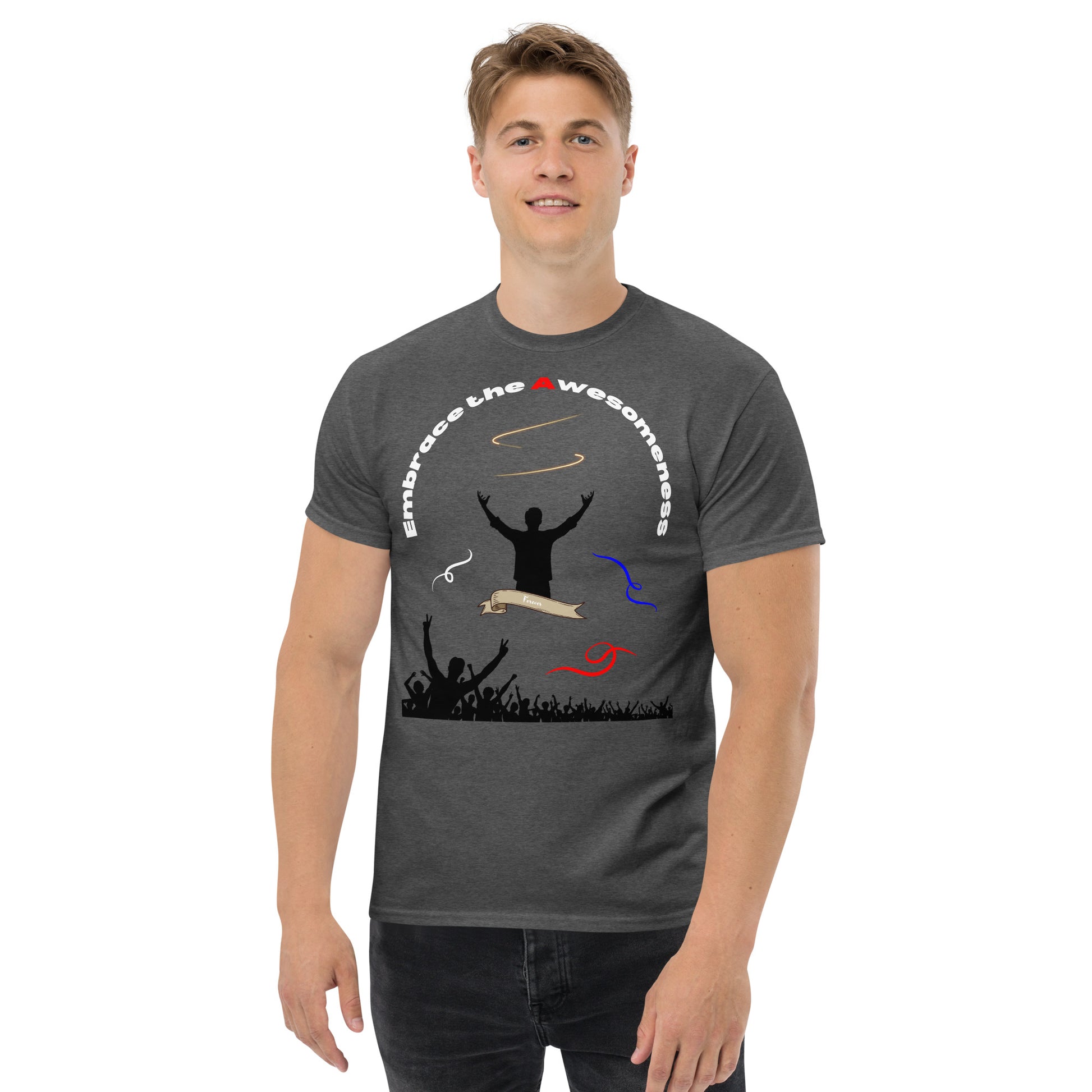 man in dark heather tshirt with words embrace the awesomeness inscribed in a half circle around a man with arms raised up you see whate blue and red colors featured and a crowd of people cheering in the background from the bottom