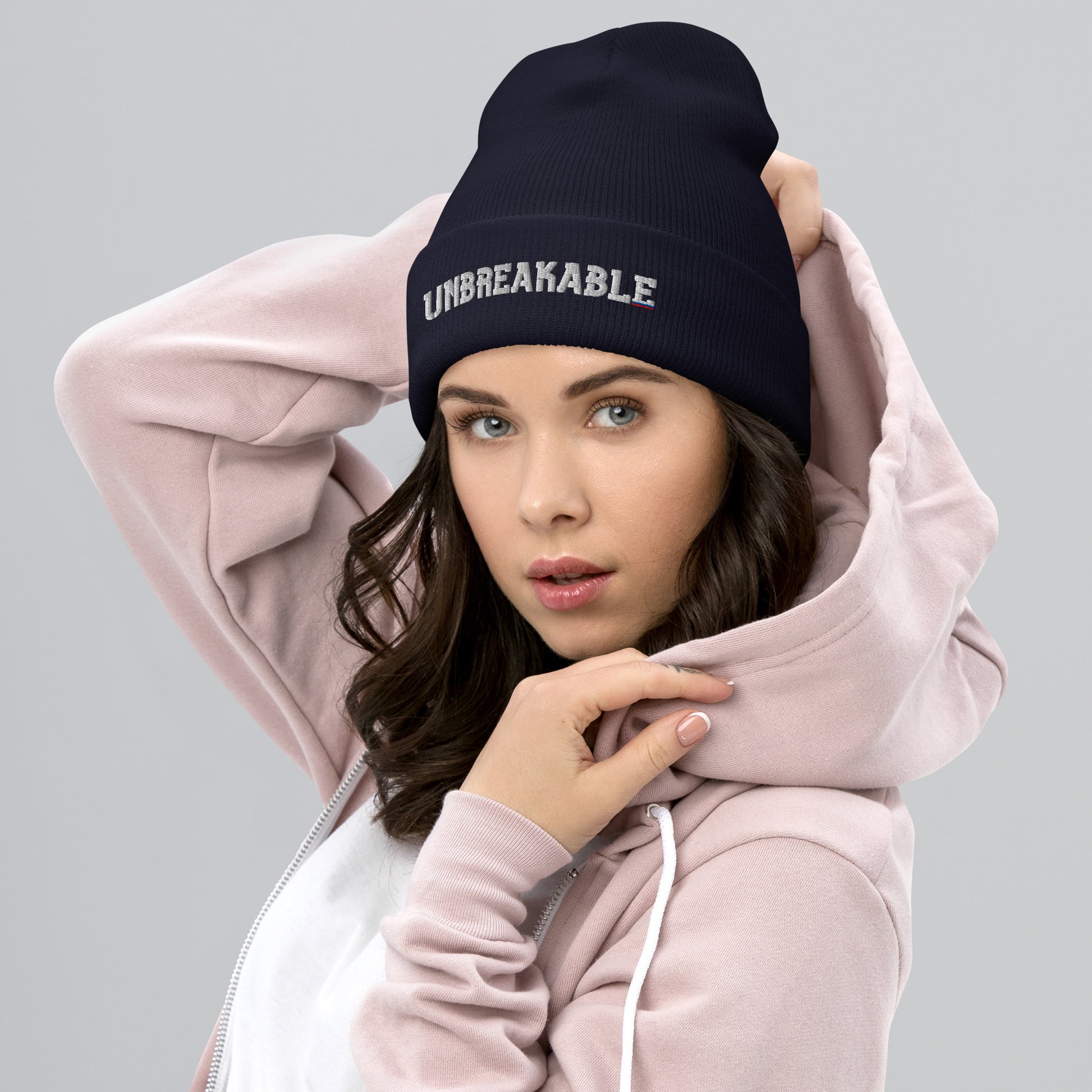 Navy UNBREAKABLE Russian cuffed beanie with embroidered white, blue, and red accent lettering styled with hoodie.