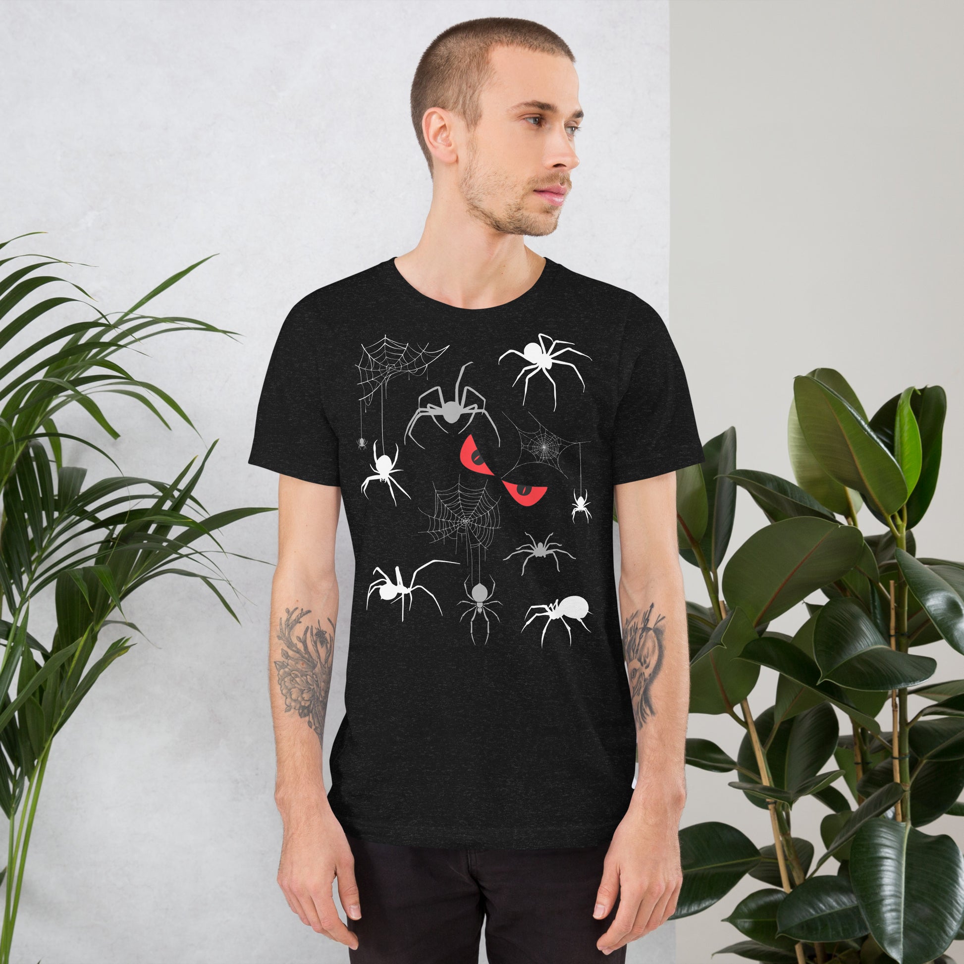 Man in a unisex black heather t-shirt with creepy spiders, spider webs and malicious red eyes. 