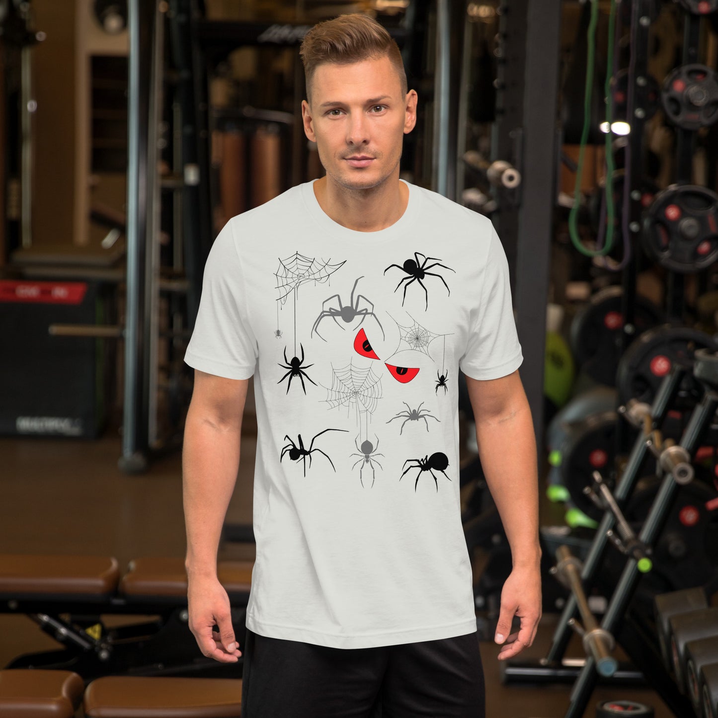 Man in a unisex silver white t-shirt with creepy spiders, spider webs and malicious red eyes. 